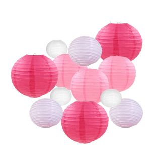 A cluster of twelve light pink, medium pink, and dark pink circular paper lanterns 
