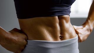 a photo of a woman with strong abs