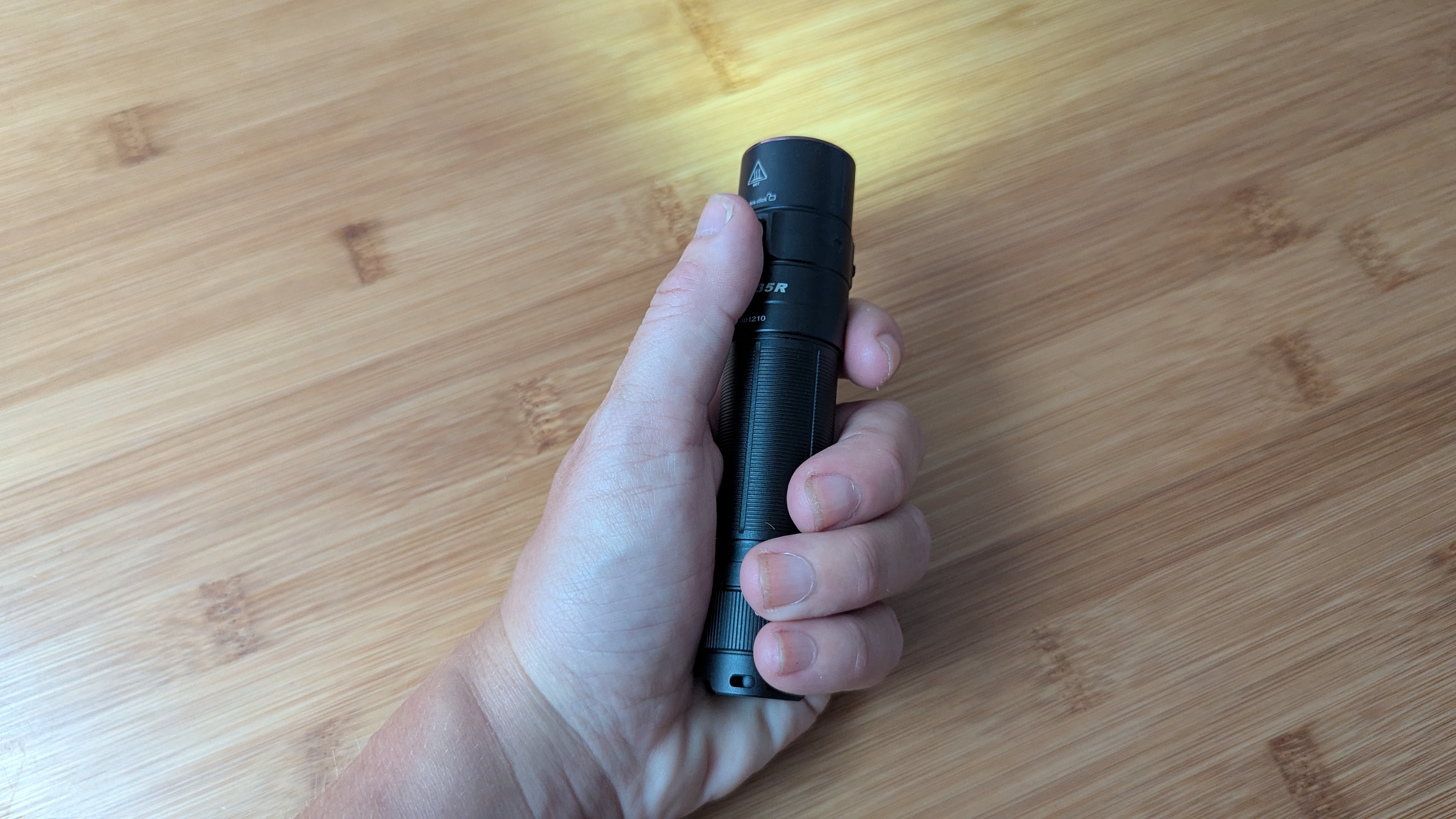 Fenix E35R flashlight being held by the reviewer during review