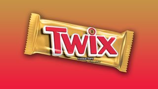 A Twix bar on a red and yellow background. 