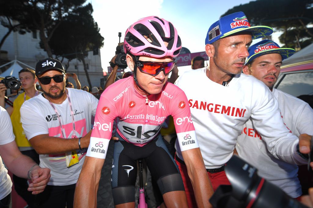 Chris Froome (Team Sky) is ushered to the podium