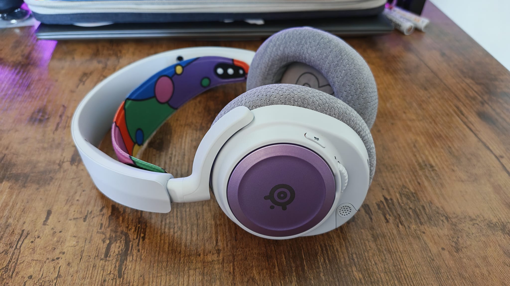 Purple and mulitcolored accessories on The SteelSeries Arctis Nova 7P