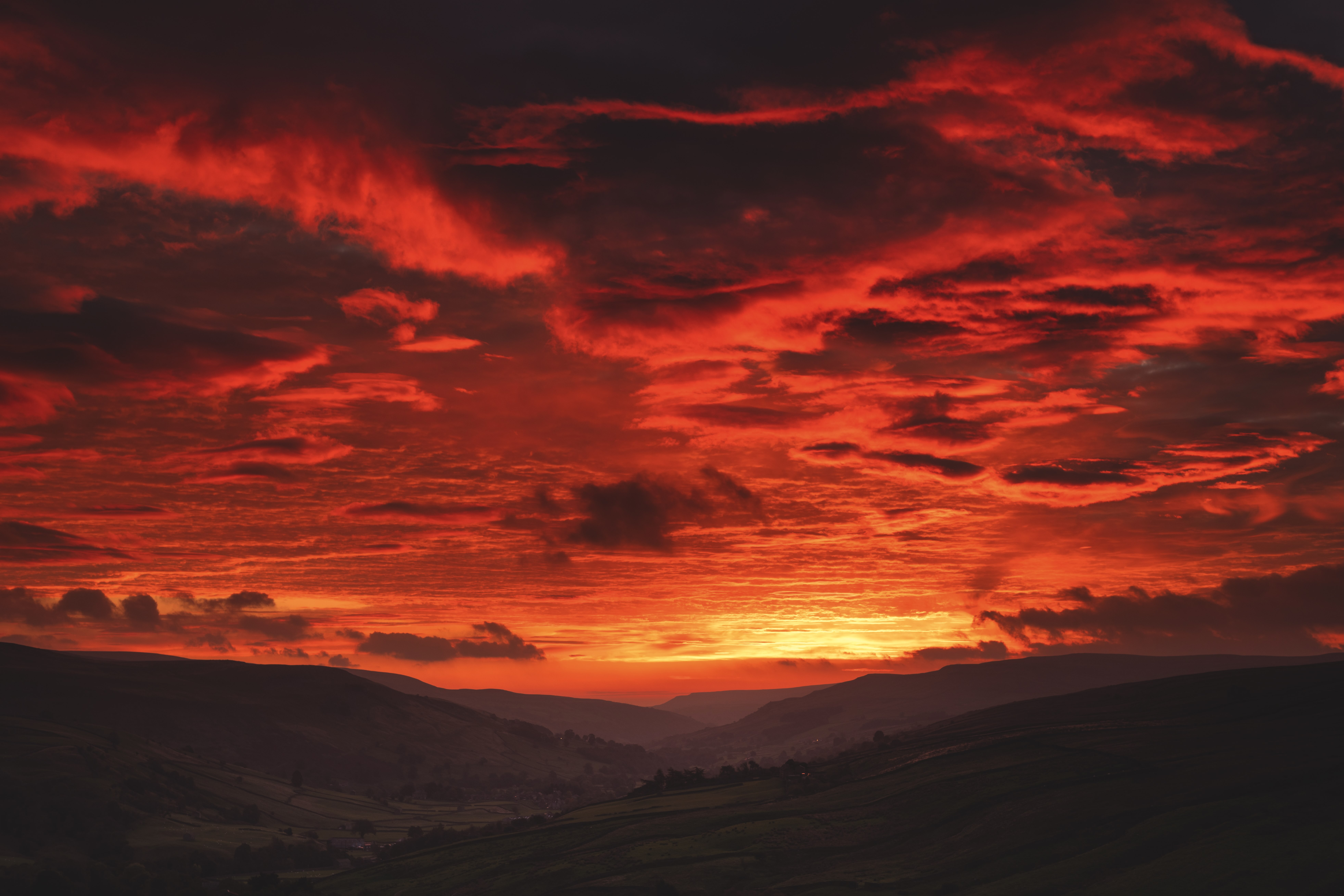 Fiery sunrise over a valley in Yorkshire Dales.