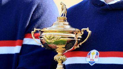 A close-up of the Ryder Cup trophy held by an American