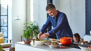 man cooking a healthy dinner for his family