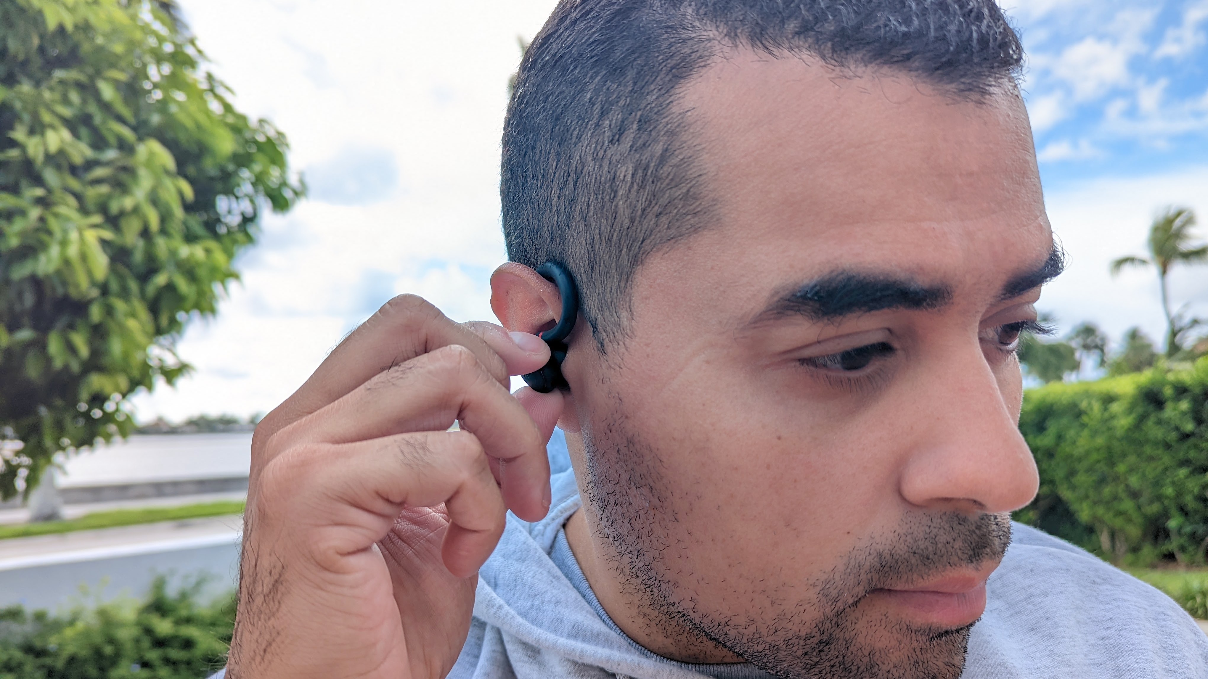 Our reviewer testing the Anker Soundcore Sport X10's physical buttons