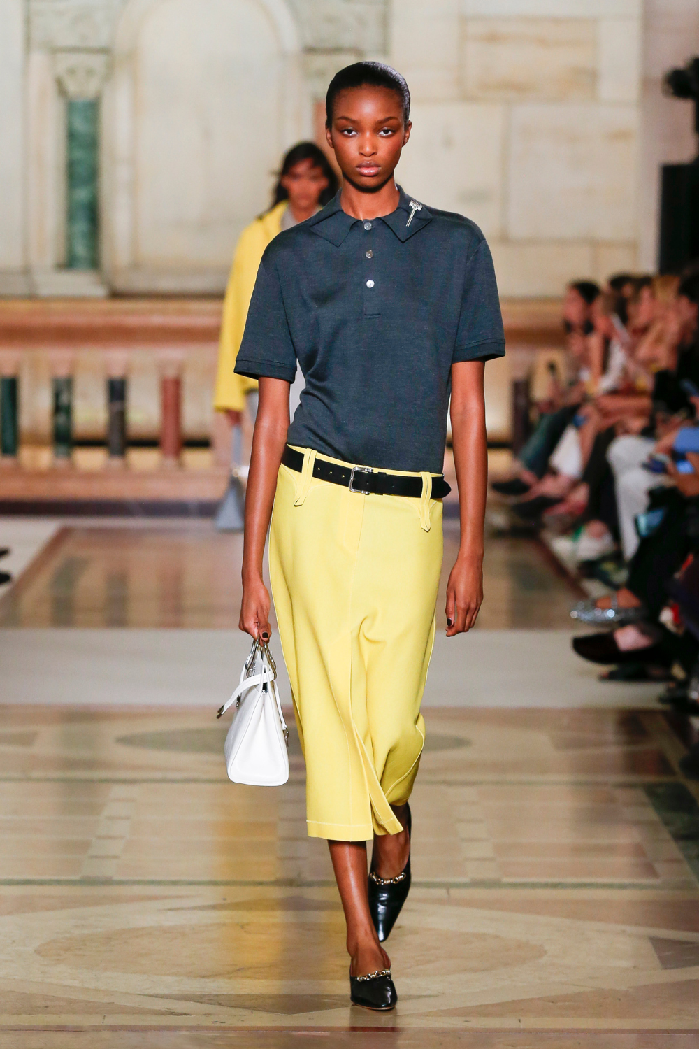 Tory Burch Spring/Summer 26 runway look - navy polo yellow skirt