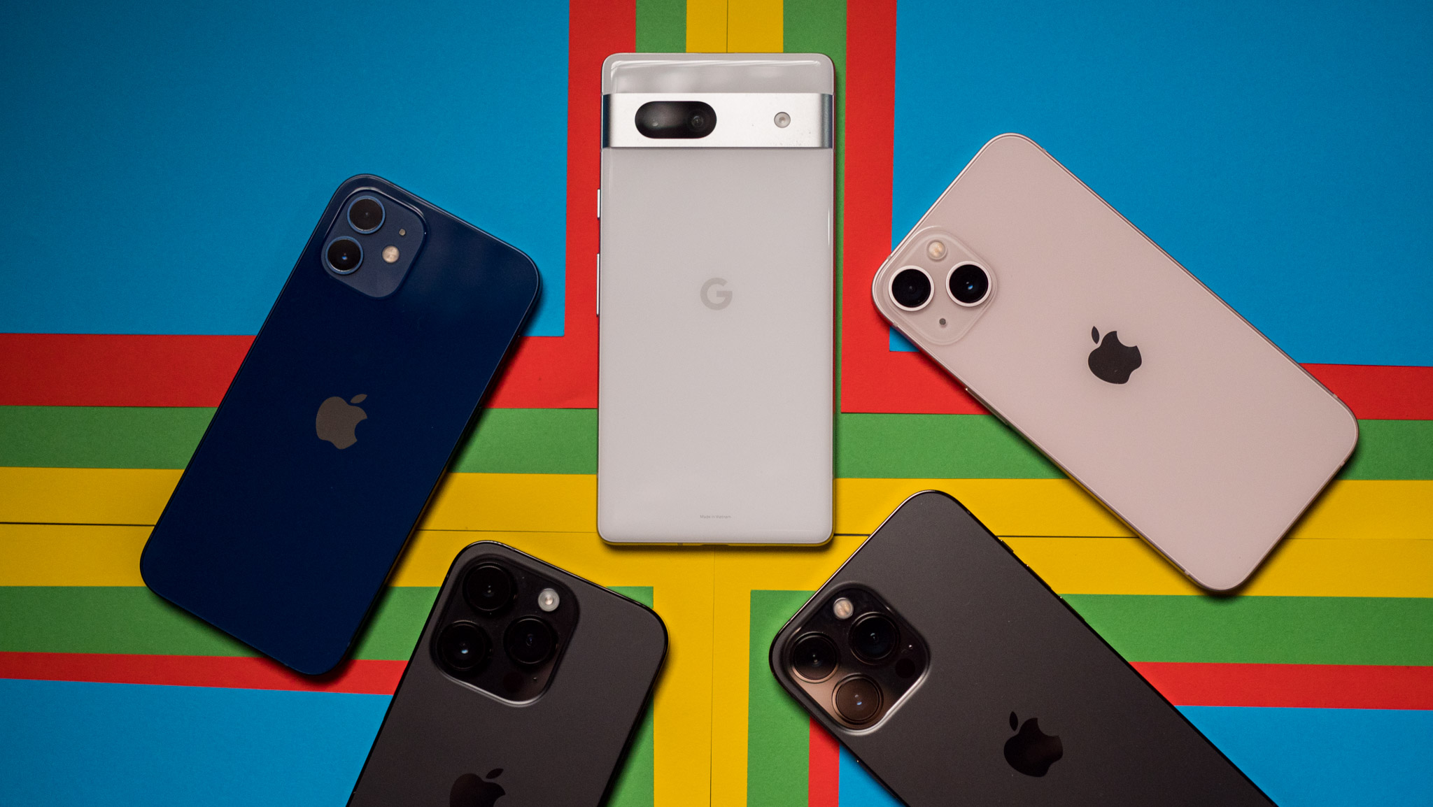 Google Pixel 7a next to iPhones