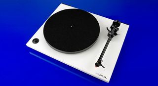 Rega RP1 Performance pack white turntable on blue background