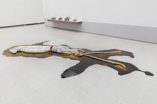 Squid-like artwork on white gallery floor