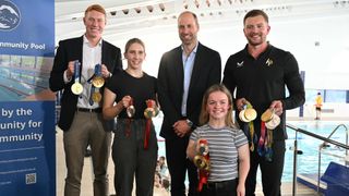 Prince William, Prince of Wales, poses for a picture with British Olympians and Paralympians Adam Peaty (R), Tom Dean (L), Maisie Summers-Newton (front R) and Louise Fiddes (2nd L) during a meeting with Olympians and Paralympians at the start of his visit to Birtley Community Pool