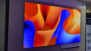 LG G4 OLED TV mounted on wall showing abstract image
