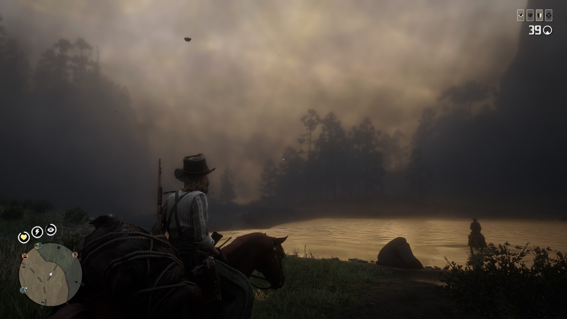 Red Dead Online - A player on horseback rides beside a rive on a foggy morning.