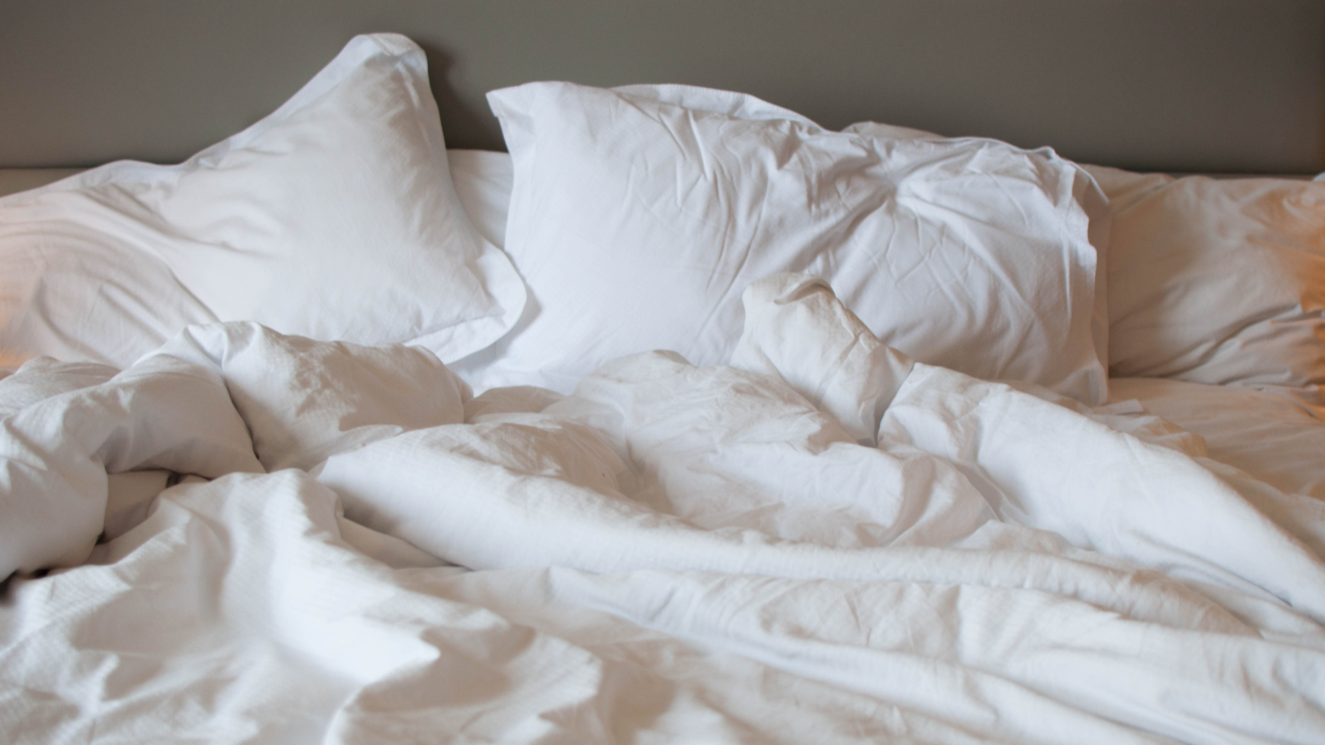 Unmade white bed sheets