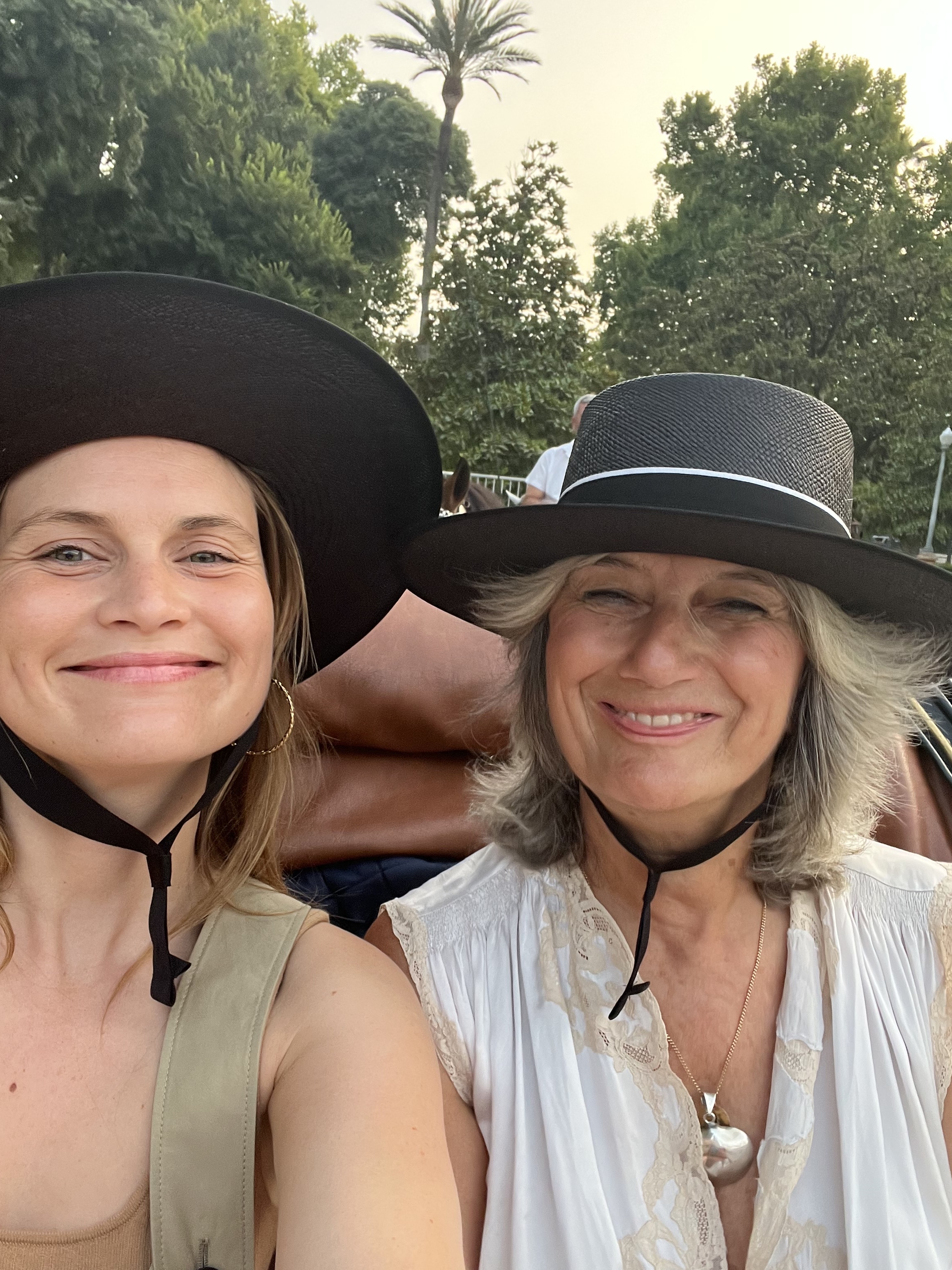 French editor and fashion creative Eugenie Trochu poses with author Sophie Fontanel wearing black wide-rim hats