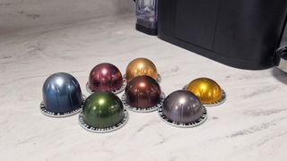 Nespresso Vertuo pods on a white countertop, with their unique barcodes on show