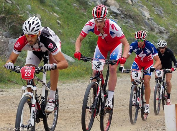 Adam Morka (Trek Canada) leading a long train of riders down the initial dirt road.