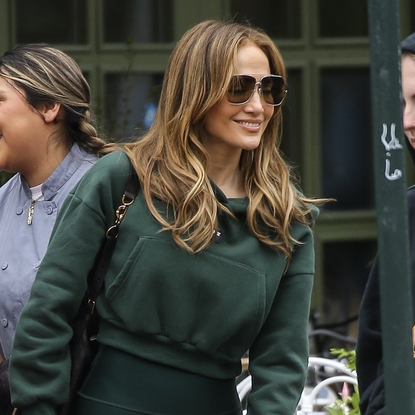Jennifer Lopez was seen walking casually outside a caf&eacute; in New York City, dressed in a dark green cropped hoodie and high-waisted leggings. She accessorized with oversized sunglasses and a black crossbody bag, radiating effortless style and joy as she engaged with friends. Jlo was all smiles after recently performing at 2025 Saudi Arabian Formula 1 Grand Prix.