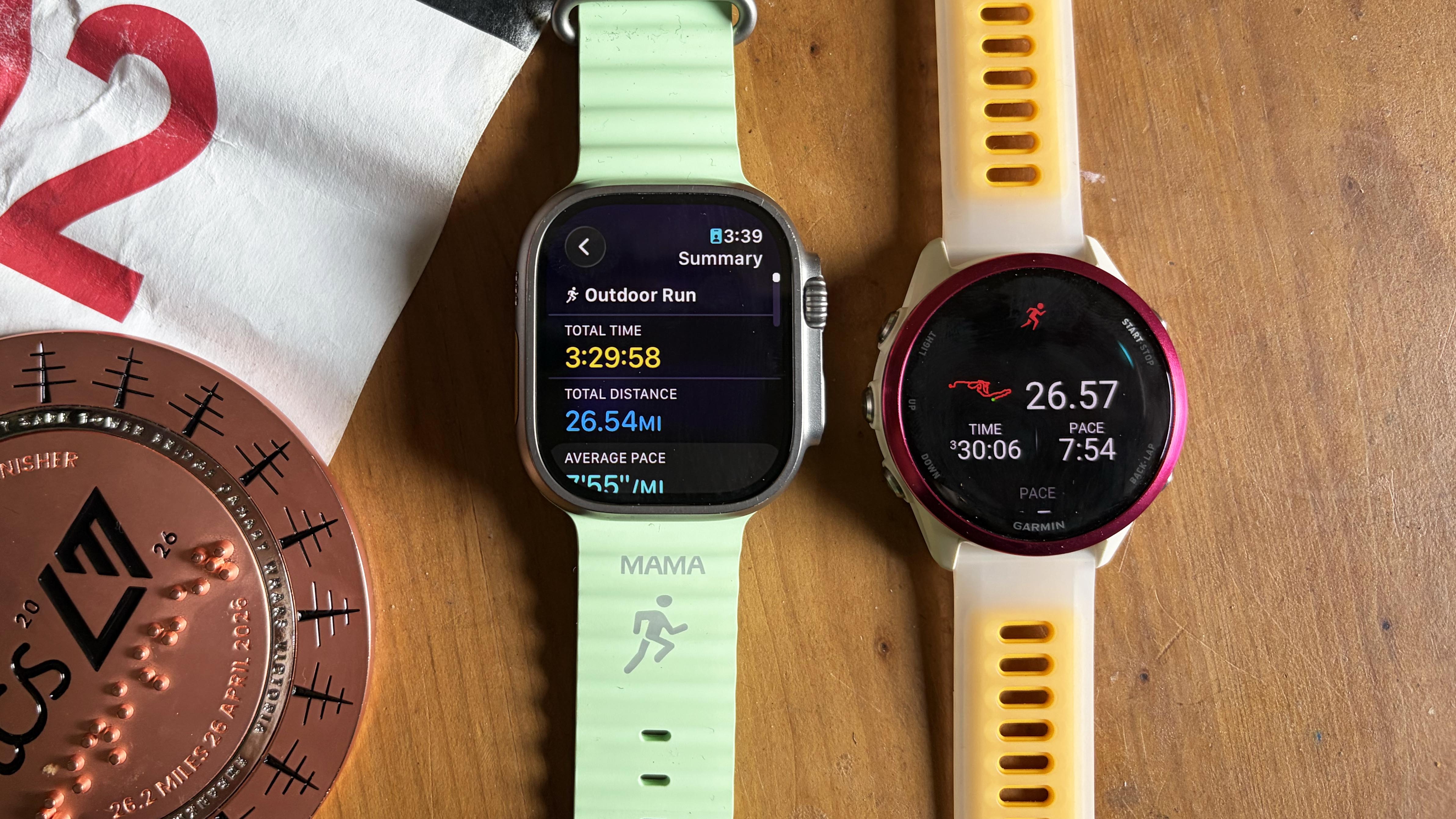 a photo of the Apple Watch Ultra 3 and Garmin Forerunner 570