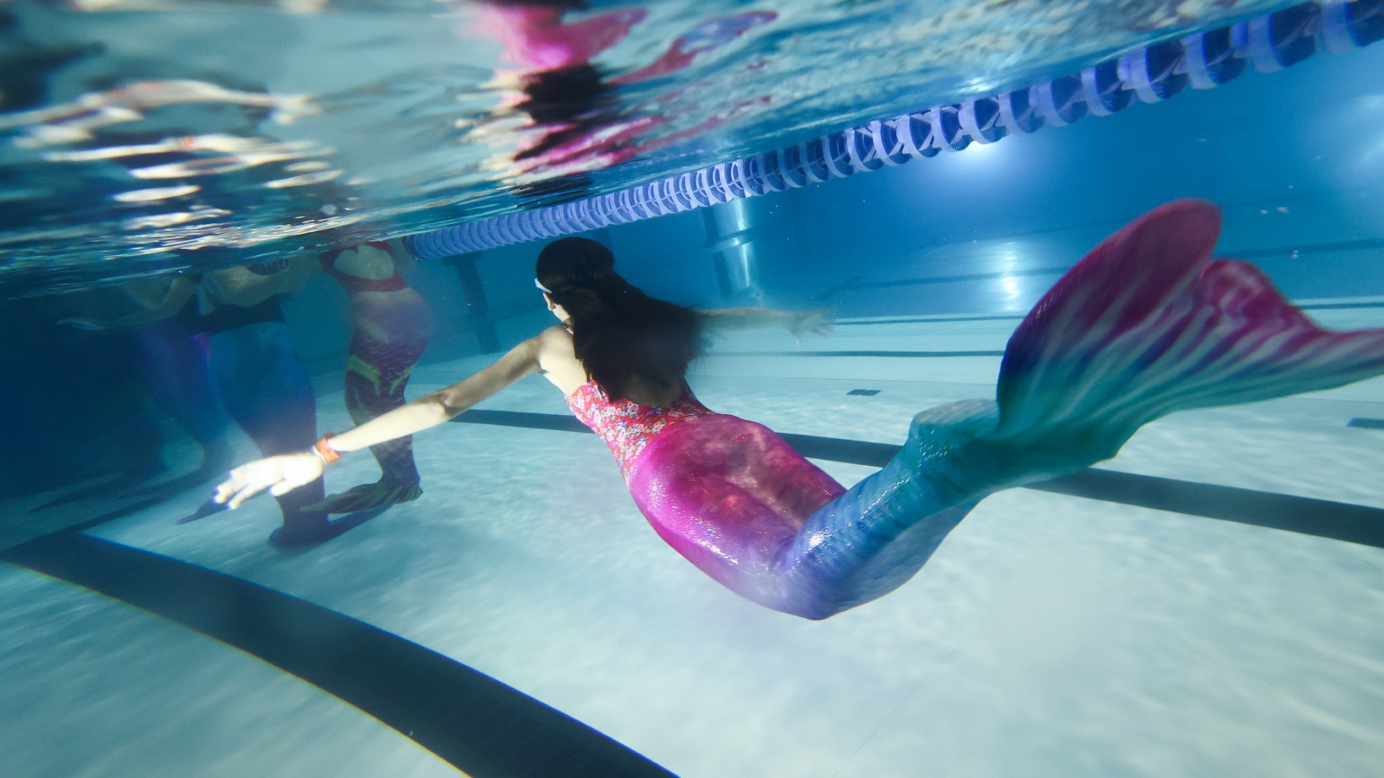 A high school student practices during the mermaiding classes at a swimming pool in Andrychow, Poland