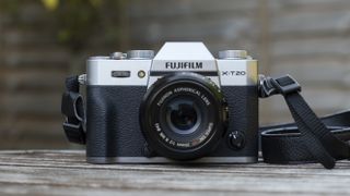 A Fujifilm X-T20 camera sitting on a garden table