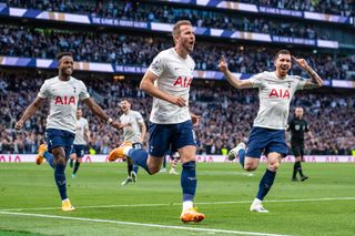 Harry Kane celebrates with Tottenham team-mates Pierre-Emile Hojbjerg and Ryan Sessegnon after scoring his second goal against Arsenal in May 2022.