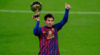 Barcelona's Argentinian forward Lionel Messi poses with the 2011 Ballon d'Or on January 15, 2012 before the Spanish Cup football match opposing FC Barcelona to Real Betis at the Camp Nou stadium in Barcelona. AFP PHOTO/ JOSEP LAGO (Photo credit should read JOSEP LAGO/AFP via Getty Images)