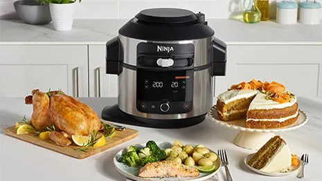 The Multi-Cooker Ninja Foodi Max 15 in 1 SmartLid surrounded by food cooked in the Instant Pot alternative