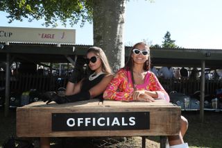 Glamorous officials for the Settrington Cup Austin J40 pedal cars races at the Goodwood Revival in Goodwood, West Sussex. Credit: Alamy