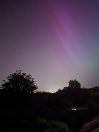 Faint purple and pink hues of the Northern lights captured in the UK.