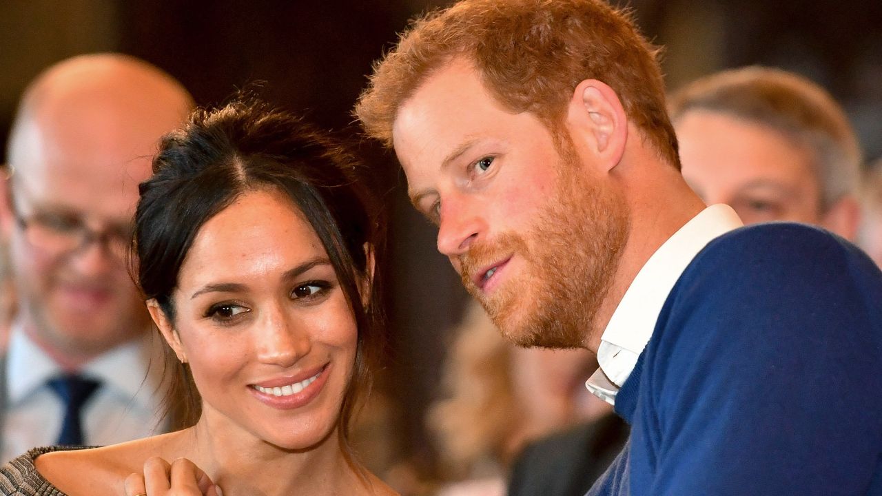 Prince Harry whispers to Meghan Markle