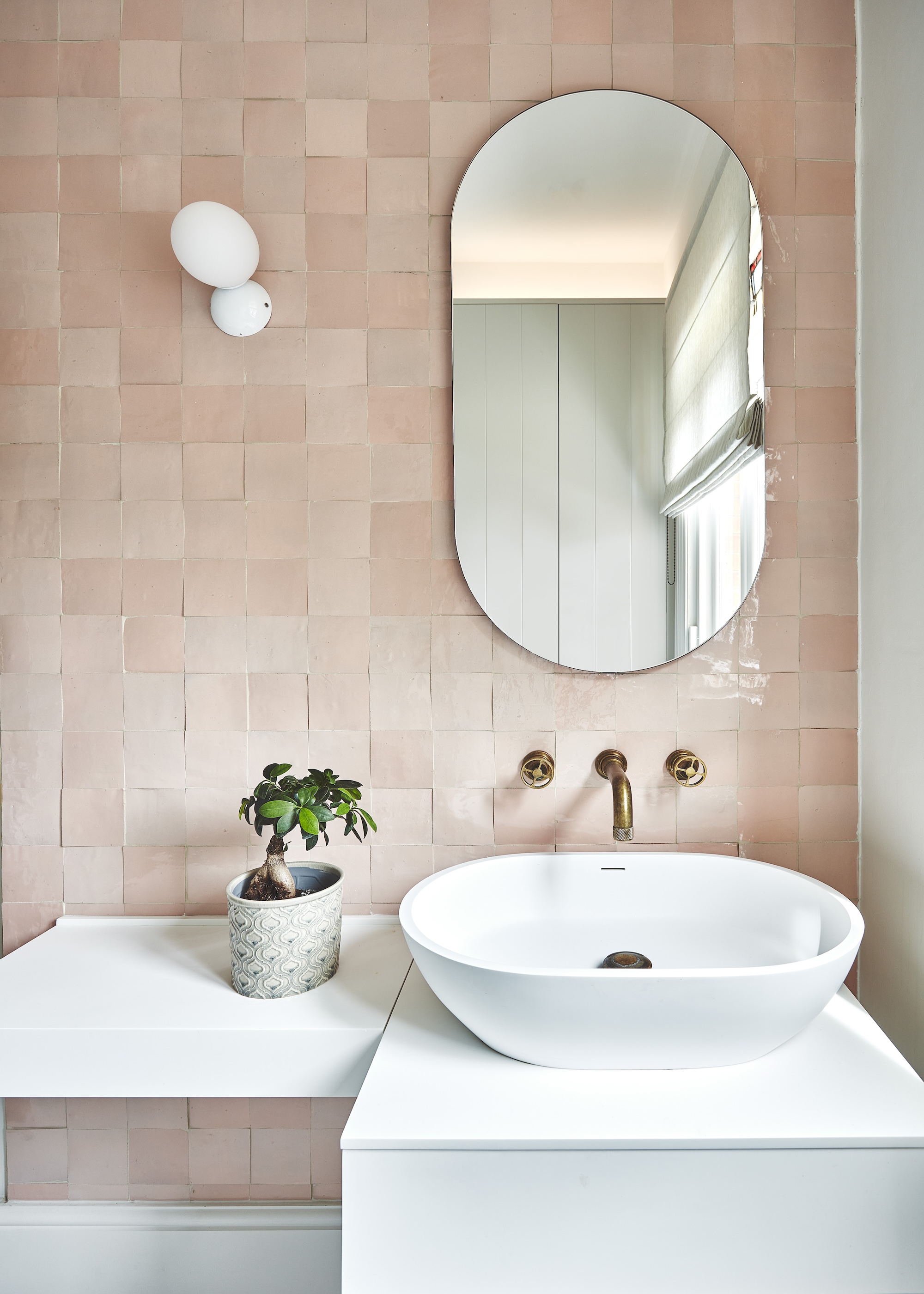 a bathroom with light pink zellige tiles