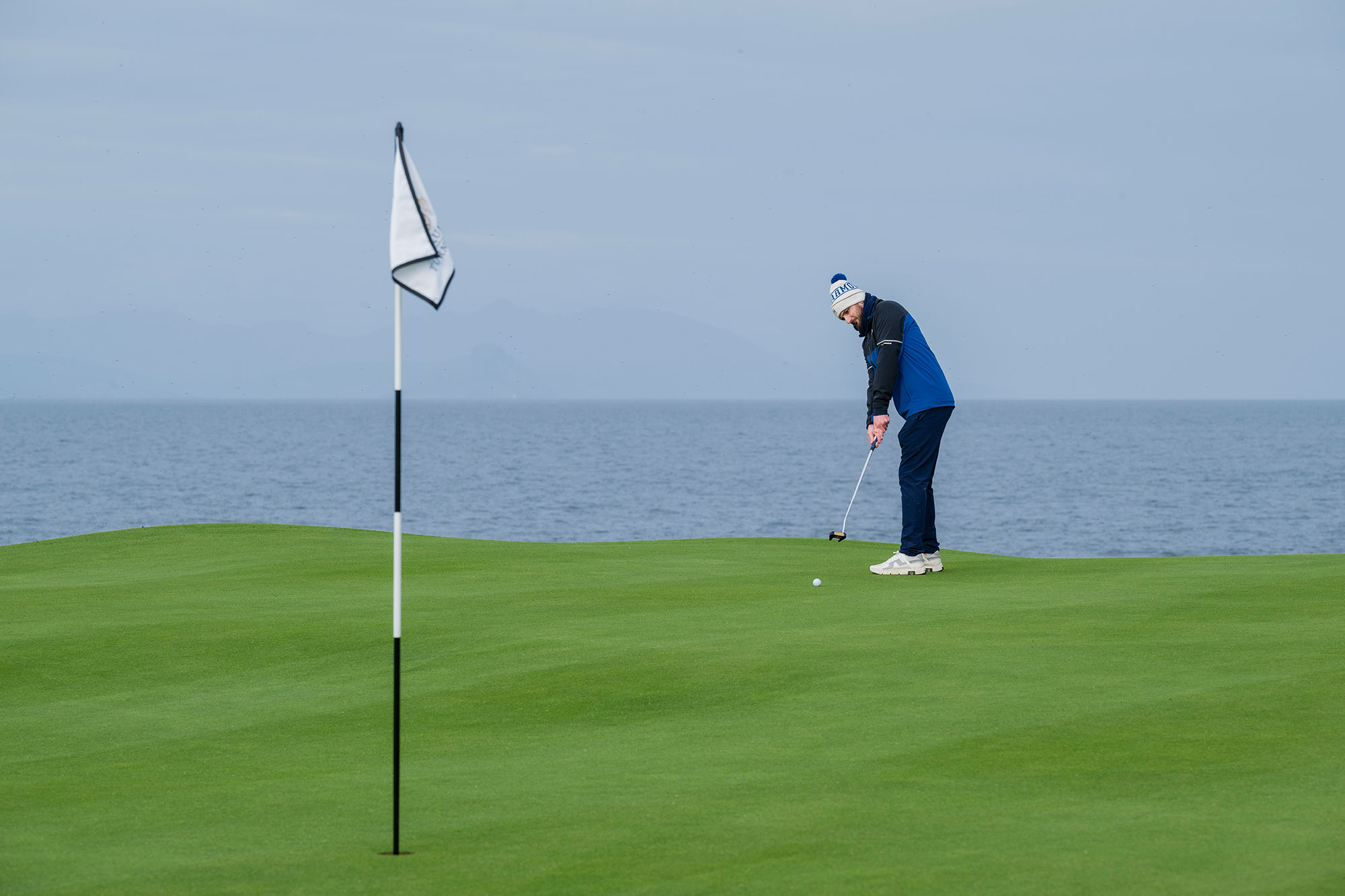 Barry Plummer playing golf on his own, putting on the 10th green at Trump Turnberry