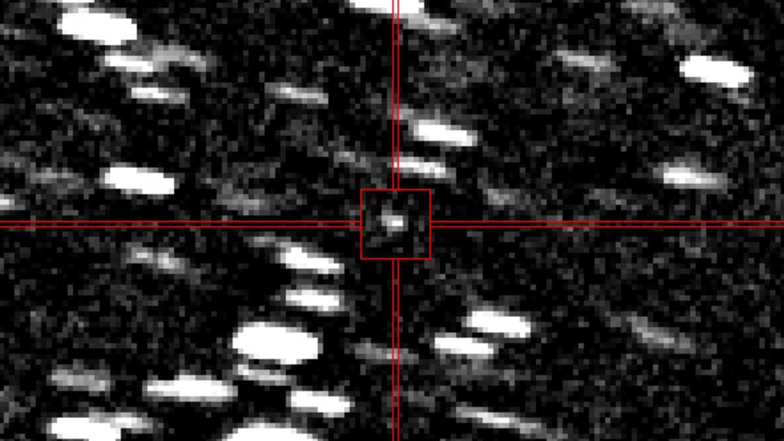 Blurry photo of a point of light shooting though a starry background