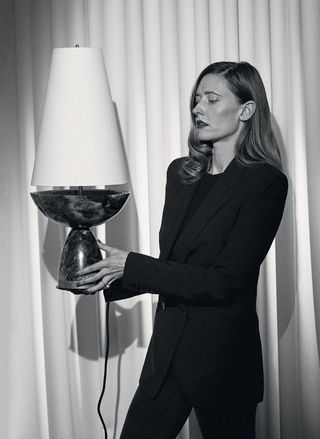 Designer Kristin Victoria Barron cradles one of her works ‘Cenotaph Minor’ lamp