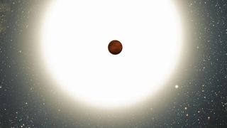 An extremely huge and bright star is behind a tiny reddish sphere.