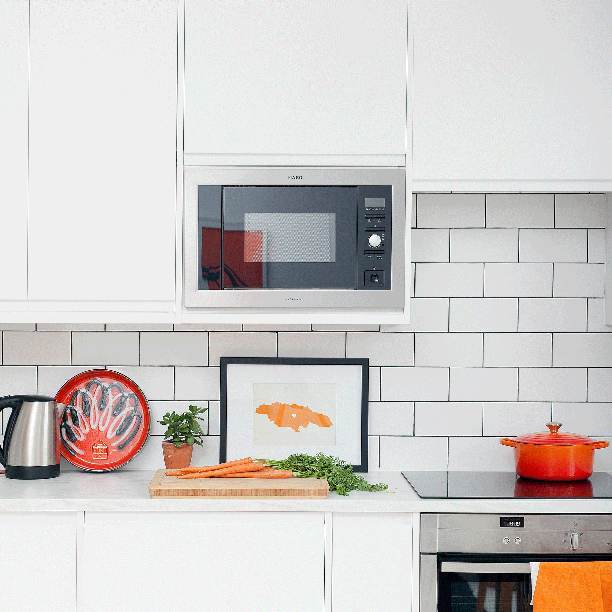 White kitchen with tiles and cooker