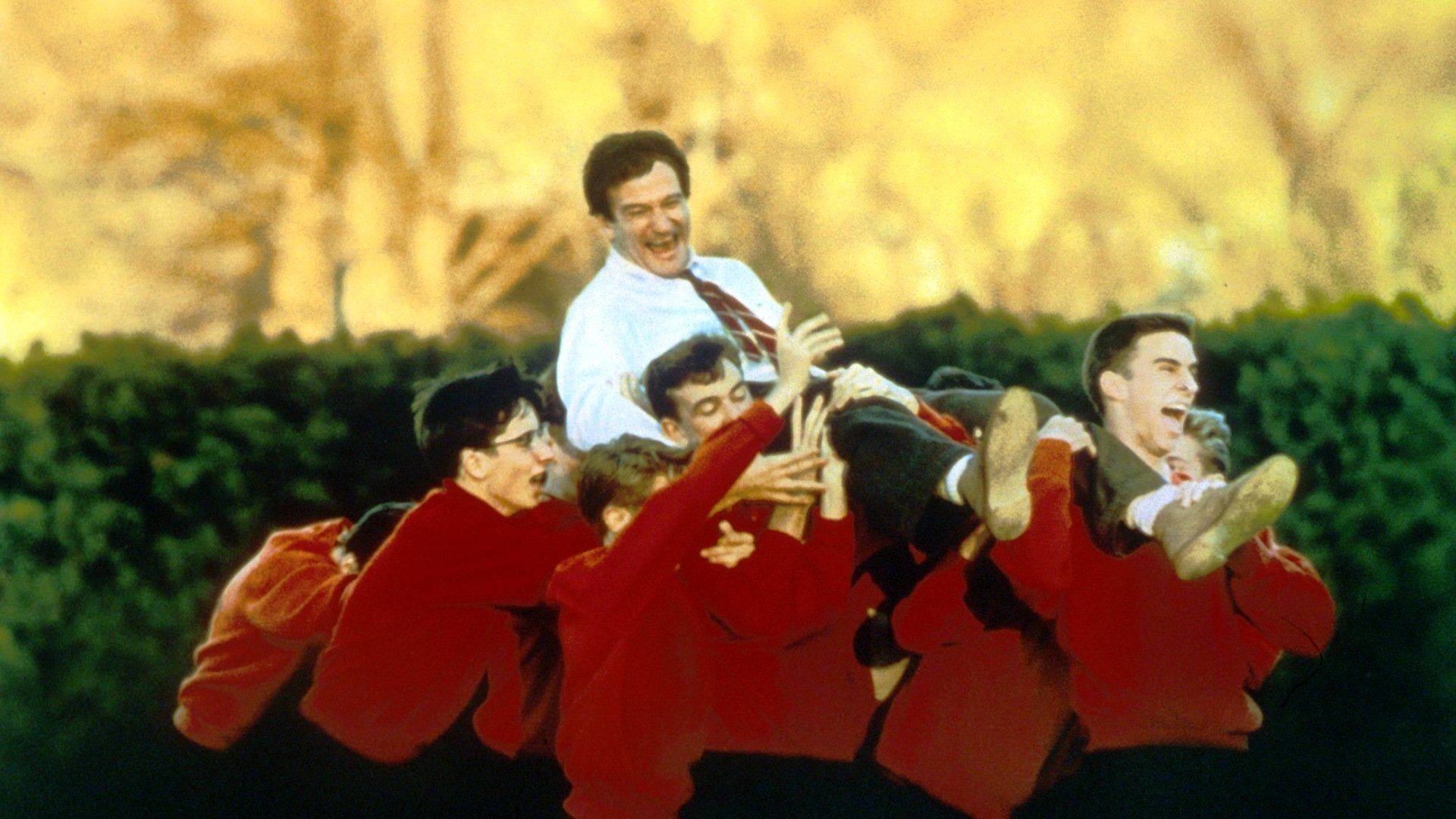 Dead Poet Society screenshot of the class holding up their teacher 