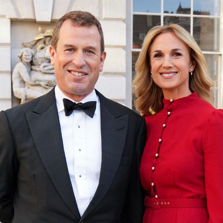 Harriet Sperling wearing a red dress standing next to Peter Phillips, wearing a tux