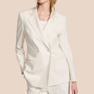 Flat lay image of woman wearing white blazer