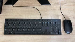 Dell XPS 8960 review unit on desk, keyboard and mouse showing