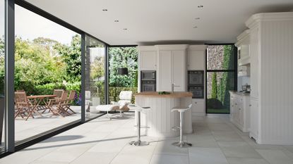 kitchen with large sliding doors leading out to a terrace with porcelain floor tiles