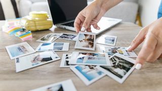 Woman looking through pile of photographs