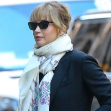 Jennifer Lawrence was spotted in New York wearing a patterned black maxi dress, a black coat, a white scarf, and patent leather boots