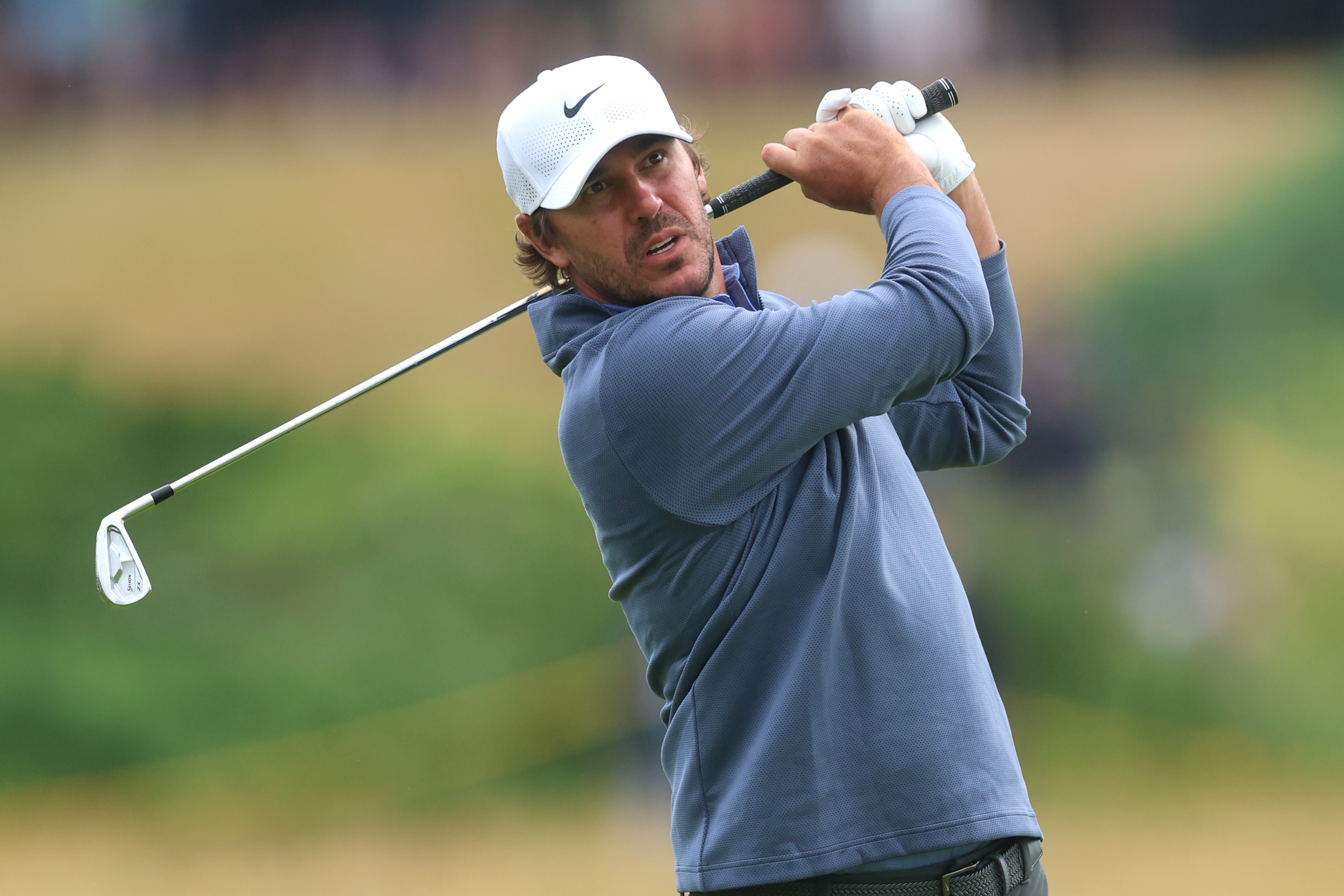 Brooks Koepka hits an iron