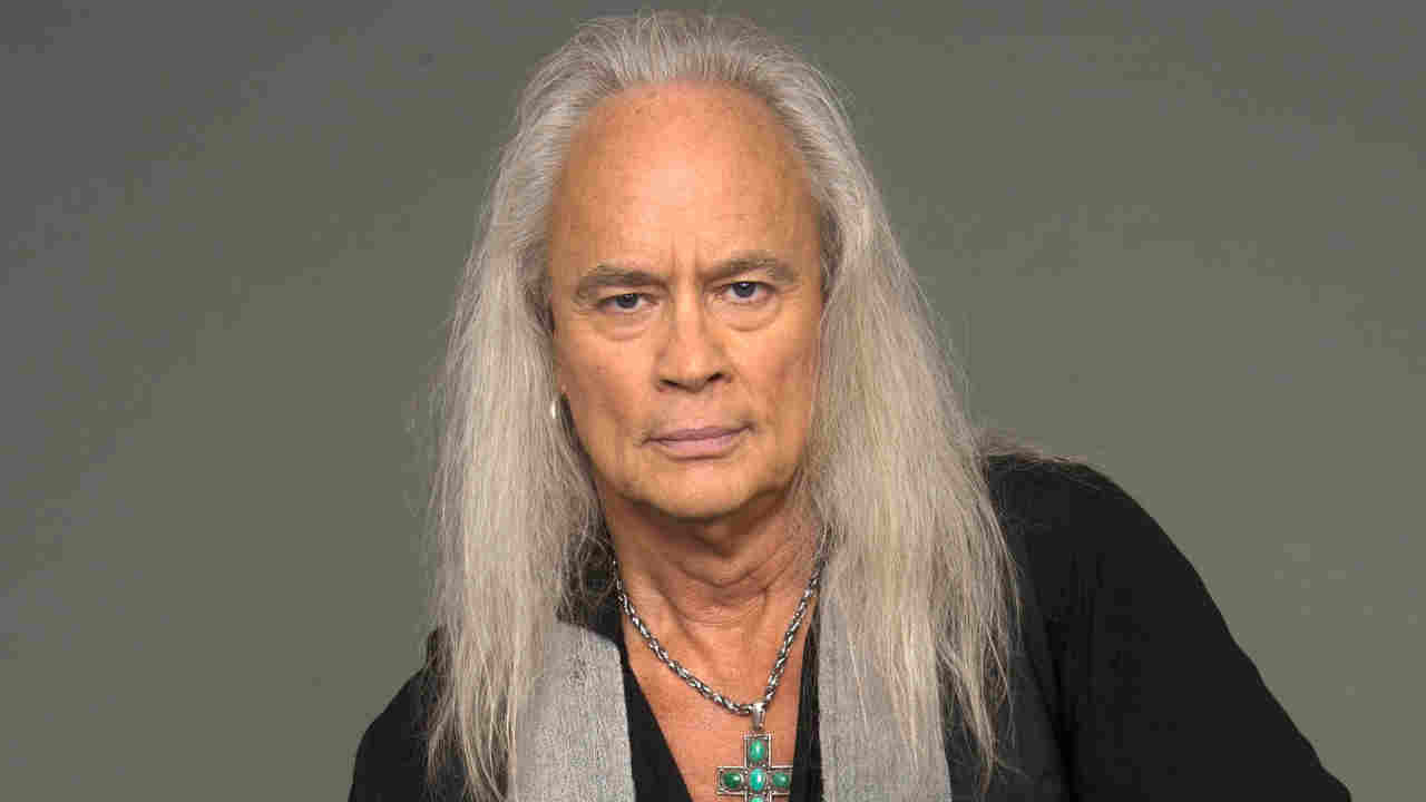 Rickey Medlocke posing for a photograph in 2014