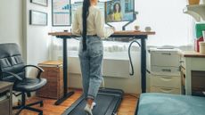 Woman working while walking on an under-desk treadmill