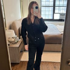 Nikki wears a black cardigan and black H&M jeans.