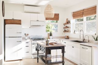white kitchen with natural finishes and a white retro fridge