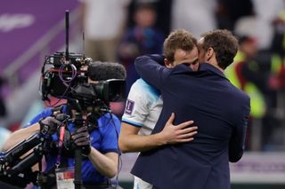 England manager Gareth Southgate shares an embrace with captain Harry Kane after the defeat to France at the 2022 World Cup.